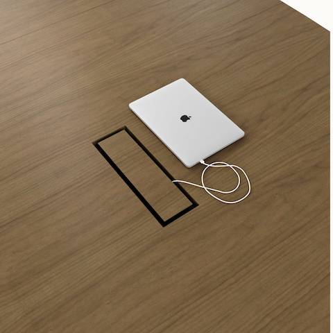 Detail shot of tabletop power access on a Highline Fifty Conference Table by DatesWeiser in Natural Flat Cut Walnut.