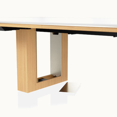 Detail shot of open wire management leg on Highline Fifty Conference Table by DatesWeiser in Glacier White Corian and Natural Rift Cut Oak with Satin Nickel base trim.