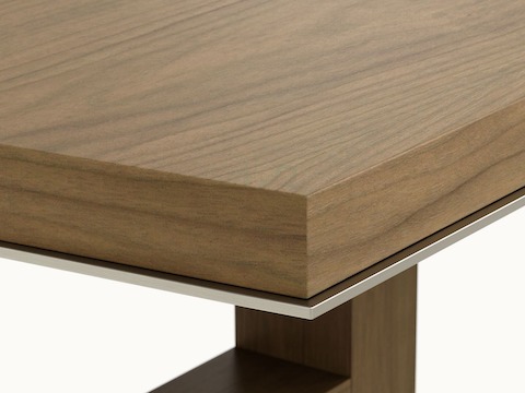 Edge detail shot of a boat-shaped Highline Fifty Conference Table by DatesWeiser in Natural Flat Cut Walnut with a Satin Nickel edge.