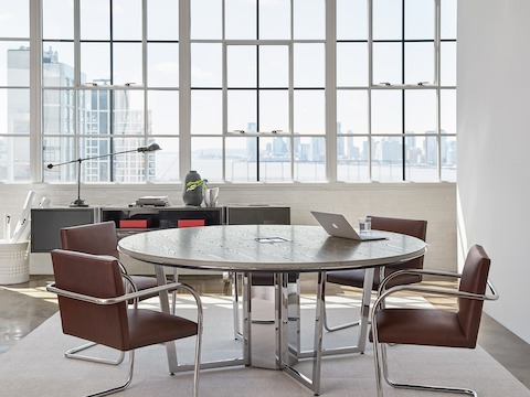Highline Round Meeting Table by DatesWeiser in a Meeting Room setting with credenza in background.