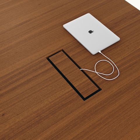 Detail shot of closed tabletop power access on Highline Vector Conference Table by DatesWeiser in Natural Quarter Cut Walnut.