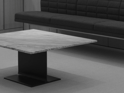 Black-and-white image of an I Beam coffee table with a marble top in an executive lounge. Black-and-white image of an I Beam coffee table with a marble top in an executive lounge.
