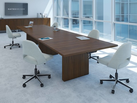 JD Conference Table by DatesWeiser with undermount technology surrounded by chairs in a conference room setting, angled view.