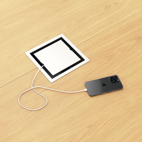 Detail shot of closed tabletop power access on a Circular Highline Meeting Table by DatesWeiser in Natural Flat Cut Oak and Satin Nickel.