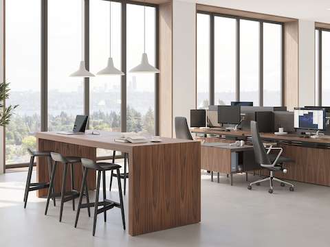 JD Waterfall Table by DatesWeiser in Walnut workstation and meeting station alongside Geiger One Open Plan workstations with Crosshatch Stools and Taper Chairs.