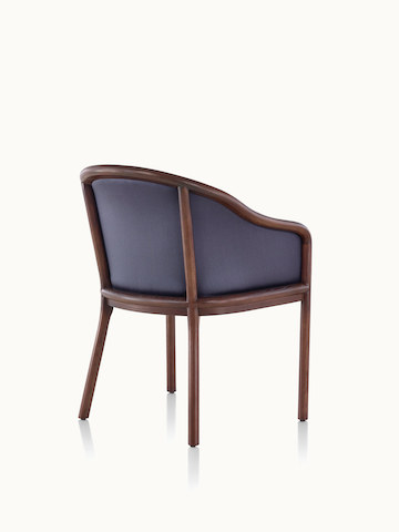 A Landmark side chair with dark blue French upholstery, a dark wood frame, and standard-height arms, viewed from behind at an angle.