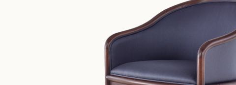 Partial angled view of the seat and back of a Landmark side chair, showing dark blue French upholstery.