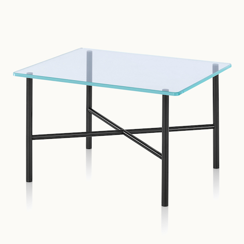 Angled view of a Layer side table with a glass top and black metal cross braces.