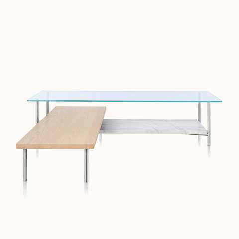 An L-shaped Layer coffee table with a glass top, marble lower shelf, and intersecting wood shelf with a light finish.