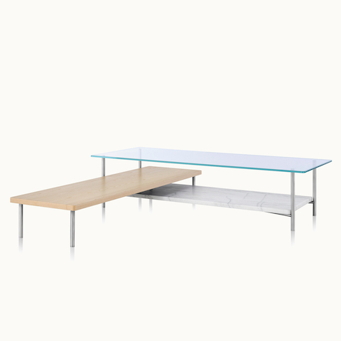 Angled view of an L-shaped Layer coffee table with glass, marble, and wood surfaces. Select to go to the Layer Tables product page.