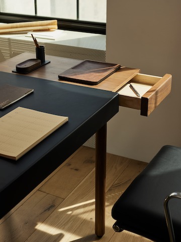 The Leatherwrap Sit-to-Stand Desk in corporate office setting detail shot with open drawer.
