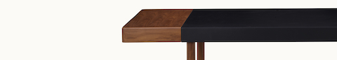 Close-up front view of a Leatherwrap Sit-to-Stand Desk in walnut and black leather.