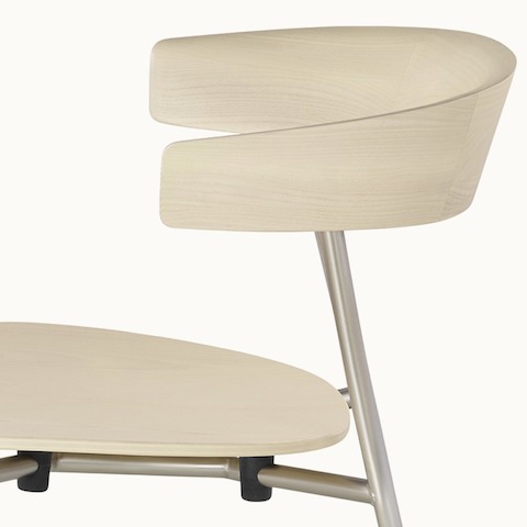 Partial side view of a Leeway side chair, showing the crescent-shaped, cantilevered backrest.