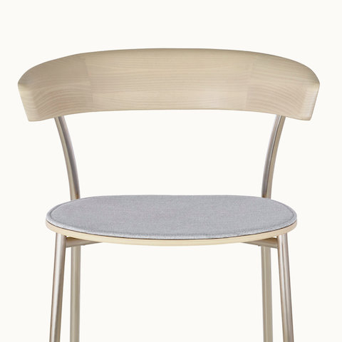 The upper portion of a Leeway Stool with a wood seat upholstered in light gray fabric, viewed from the front.