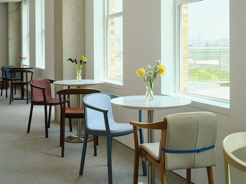 Collection of Lijn Side Chairs and Armchairs designed by Carole Baijings for Geiger in assorted finishes shown at an angle in a café setting
