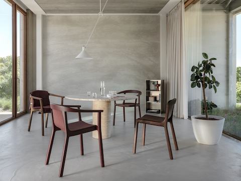 Lijn Arm Chairs and Side Chairs designed by Carole Baijings for Geiger in Red Clay and Persian Walnut frames shown in a residential setting.