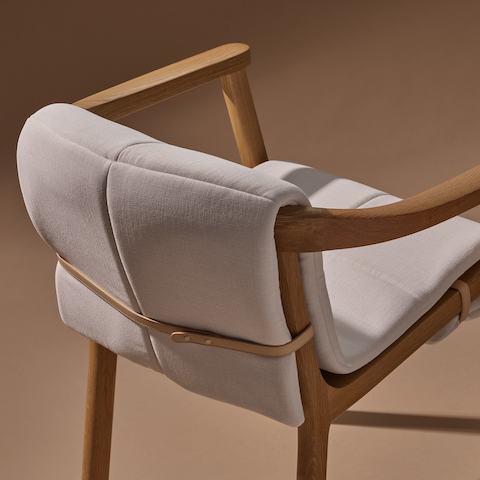 Lijn Armchair by Carole Baijings for Geiger in Natural Oak frame with quilted wrap in Vionette White Sand Mix, detail shot on a neutral background.