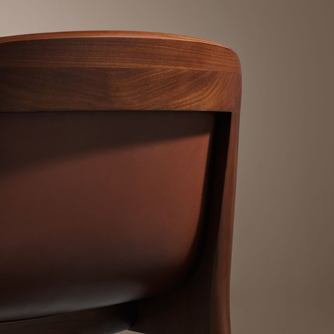 Lijn Stool by Carole Baijings for Geiger in Persian Walnut frame upholstered with Maharam Hue Leather in Bittersweet, detail shot on a neutral background. Lijn Stool by Carole Baijings for Geiger in Persian Walnut frame upholstered with Maharam Hue Leather in Bittersweet, detail shot on a neutral background.
