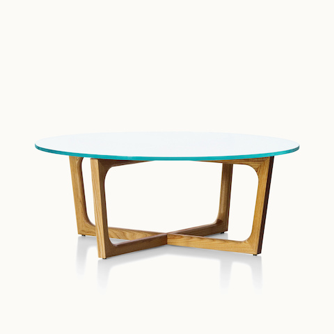 A round Loophole coffee table with a glass top and a wood base in a medium finish.