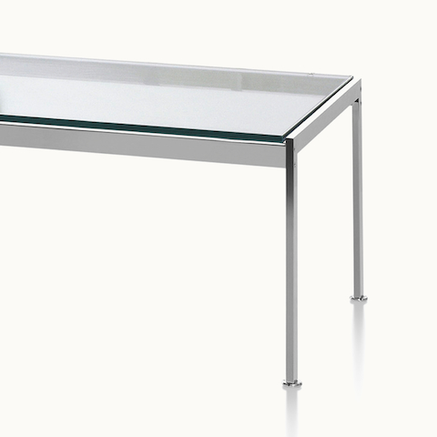 Partial view of a rectangular Metal Series coffee table with a glass top.