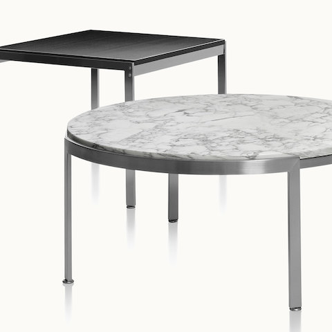 A round Metal Series coffee table with a stone top in the foreground and a square Metal Series side table in the background.