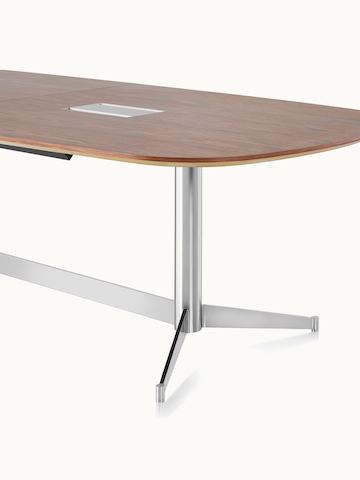 Partial angled view of an oblong MP Conference Table with a medium-tone recograin rosewood finish.