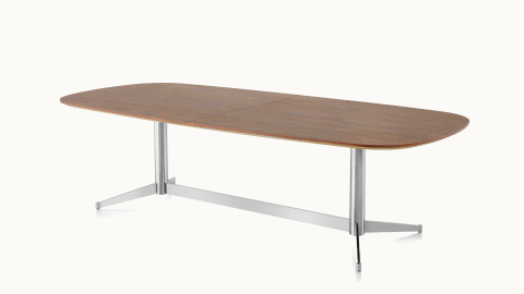 Angled view of an oblong MP Conference Table with a medium-tone recograin rosewood finish.