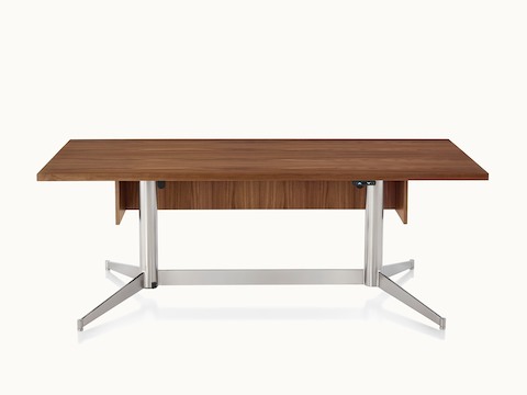 A rectangular MP Height-Adjustable Table in the seated position, viewed from the front and showing the height-adjustment button beneath the tabletop.