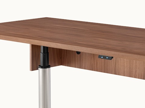 Close-up of the underside of an MP Height-Adjustable Table, showing the height-adjustment button.