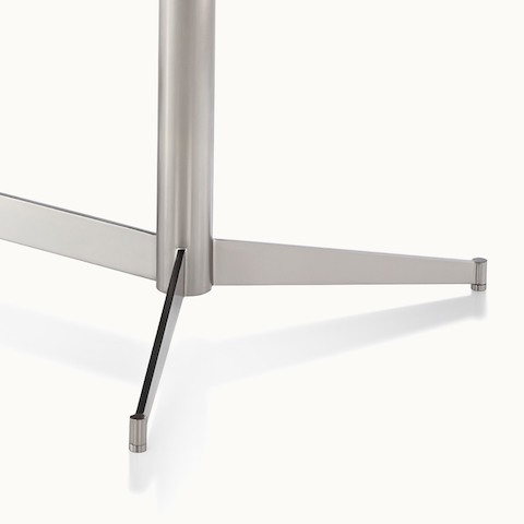 Close-up of the base of an MP Height-Adjustable Table, showing a column on flat-blade metal feet.