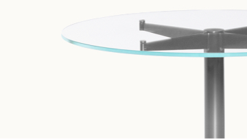 Close-up of the upper portion of an MP Occasional Table, showing a round glass top.