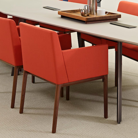 Red Nessel side chairs surround a Geiger Elsi conference table.