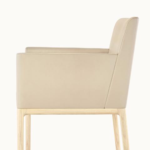 Close side view of a Nessel side chair with wraparound arms, showing the grooved corner blocks in the frame.