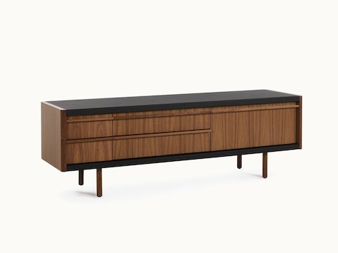 New Canaan Media Unit designed by BassamFellows for Geiger in Walnut with Black Leather shown angled on a white sweep.