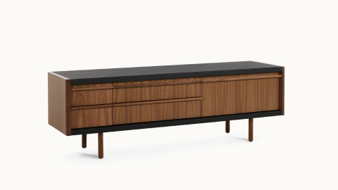 New Canaan Media Unit designed by BassamFellows for Geiger in Walnut with Black Leather shown angled on a white sweep.