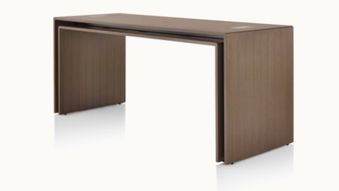 Angled view of a rectangular Peer Table in a dark wood finish.
