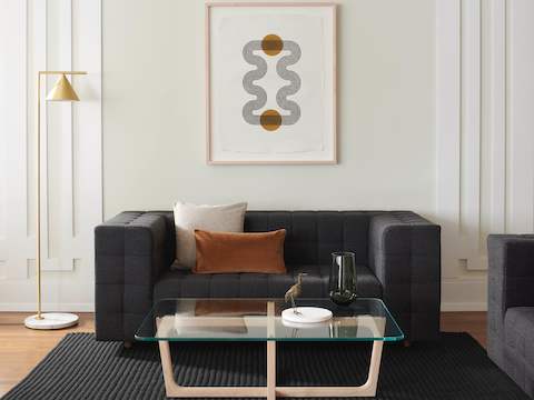 A lounge area featuring a Rapport Settee and Loophole Table.