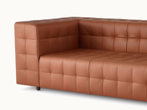 A close-up of the corner of a Rapport three-seat sofa upholstered in leather.