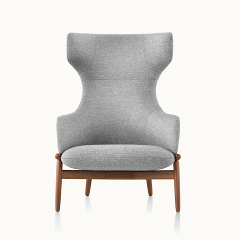 A wing-back Reframe lounge chair with light gray upholstery and a wood frame in a medium finish, viewed from the front.