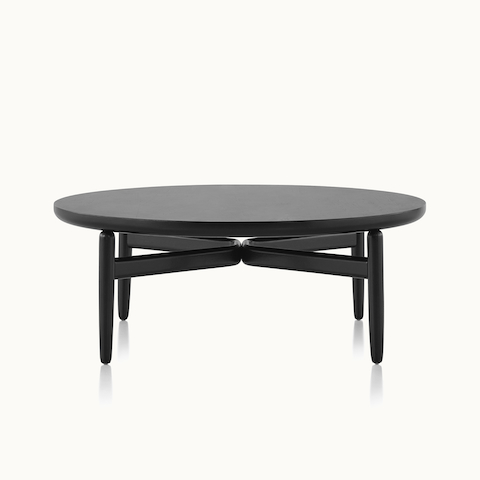 A round Reframe occasional table with a black wood finish.