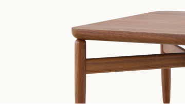The upper portion of a rectangular Reframe occasional table, showing the medium wood finish and frame.
