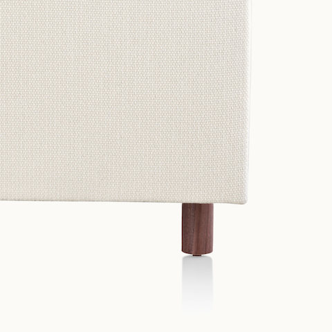 Close-up of a recessed wood leg on an off-white sofa from the Rolled Arm Sofa Group.