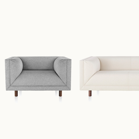 Full front view of a light gray club chair next to a partial front view of an off-white sofa, both from the Rolled Arm Sofa Group.