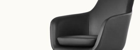 Partial angled view of the seat, back, and arms on a Saiba Chair with black leather upholstery.