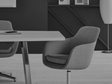 Black-and-white image of three mid-back Saiba conference chairs around a conference table.