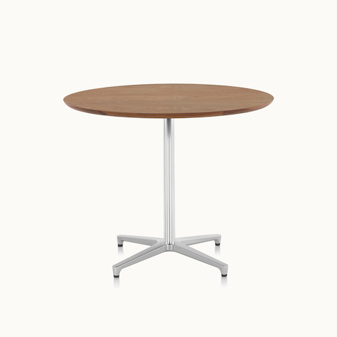A round Saiba occasional table with a veneer top and aluminum pedestal base.