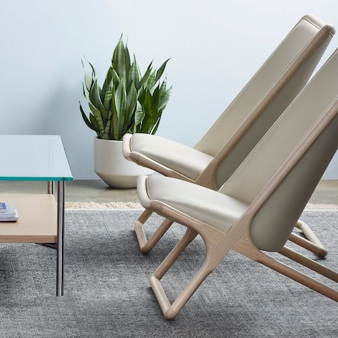 Side view of two Scissor lounge chairs in a sitting area, showing the low seat height.