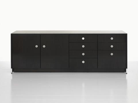A four-unit Sled Base Storage credenza with a dark wood finish and a combination of hinged doors, box drawers, and file storage.