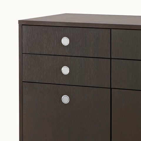 Partial view of a Sled Base Storage unit with a dark wood finish, showing three flush-mounted Flip pulls.