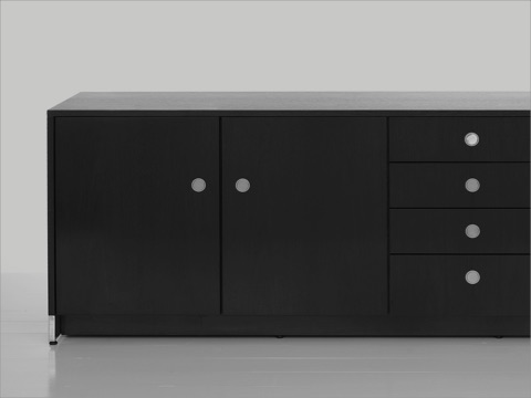 Black-and-white image of a four-unit Sled Base Storage credenza with a dark wood finish and a combination of hinged doors, box drawers, and file storage. Black-and-white image of a four-unit Sled Base Storage credenza with a dark wood finish and a combination of hinged doors, box drawers, and file storage.